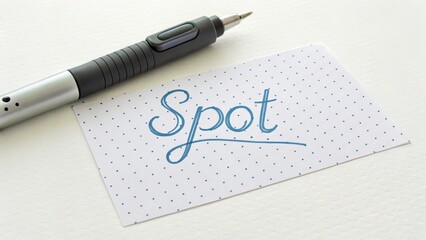 Fototapeta premium A Pen next to a Card with the Word Spot Doodled On It