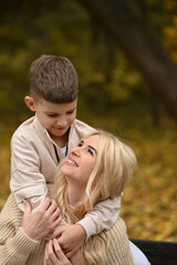 Fototapeta premium mother and son playing in the autumn park