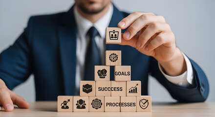 Businessman stacking cubes to build success toward business goals