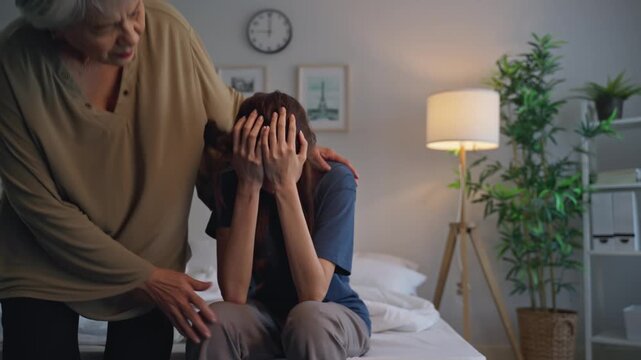 Asian elderly mother comforting upset daughter crying for life problem. 