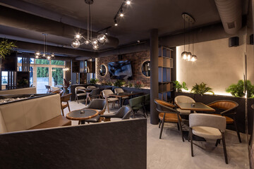 Contemporary restaurant design featuring brick walls, warm lighting, and comfortable seating area