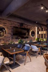 Interior of a empty hotel restaurant with brick wall