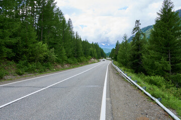 An asphalt road in the Altai Mountains. A picturesque place in the mountains.