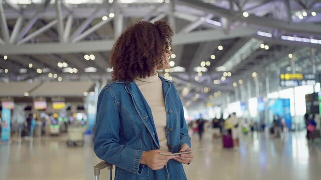 Latino woman walking through airport terminal toward the boarding gate. 