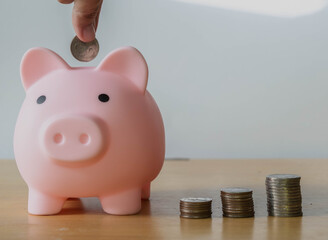 Pink piggy bank on a desk with a jar of coins and money, a piggy bank , family savings, saving jar