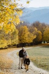 Family enjoying autumn walk, pregnant mom, happy parenting