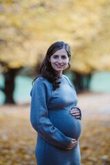 Pregnant woman smiling enjoying maternal journey outdoors