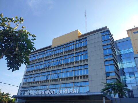 Modern hospital building with Emergency installation sign against the Blue Sky 