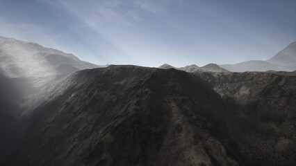 Fototapeta premium Breathtaking mountains stretch into the horizon, illuminated by the soft light of dawn. Shadows play across rugged terrain, showcasing the serene beauty of the natural world.