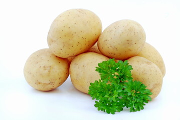 Fresh raw potatoes with parsley isolated on white background.