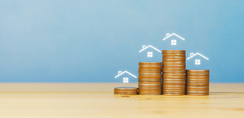 rising stacked coins with house icon. copy space