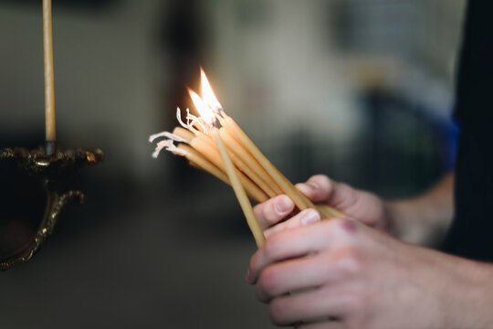 hand holding a burning candle