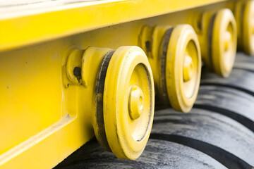 Closeup of Yellow Industrial Vehicle Wheels and Chassis