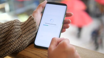 The video shows efficient cloud technology usage in a retail environment, with hands uploading visual content to remote storage and getting successful transfer notification. Perfect for cloud service