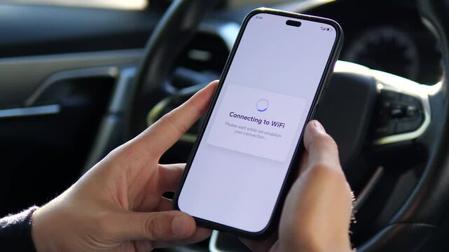 A man's hands in a vehicle successfully establish a Wi-Fi connection through smartphone settings, tapping the connect button and receiving immediate confirmation. This scene represents modern