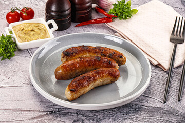 Delicous natural roasted sausages in the plate