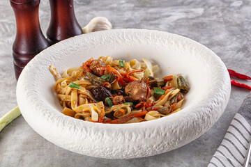 Asian cuisine udon with chicken and vegetables