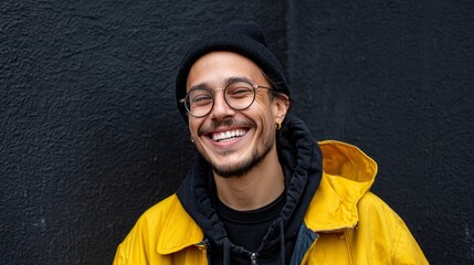 Man smiling in yellow jacket.