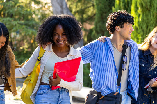 Diverse students walking together, laughing on campus
