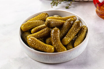 Marinated canned green cornichon cucumbers