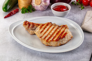 Tasty hot grilled bone steak served sauce