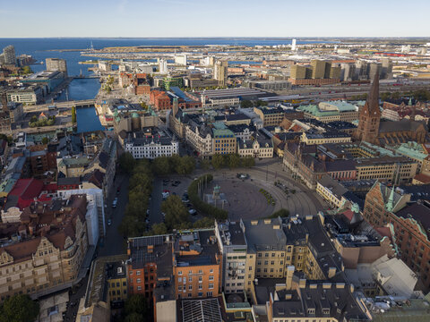 Aerial view of the historic Stortorget square, where cobblestone streets meet modern architecture under a vast sky, Malmo, Sweden.