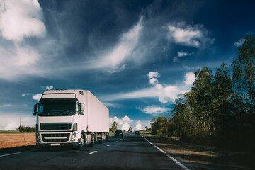 Truck On Country Road. Tractor Unit, Prime Mover, Traction Unit In Motion On Countryside Road In Europe. Business Transportation And Trucking Industry Concept