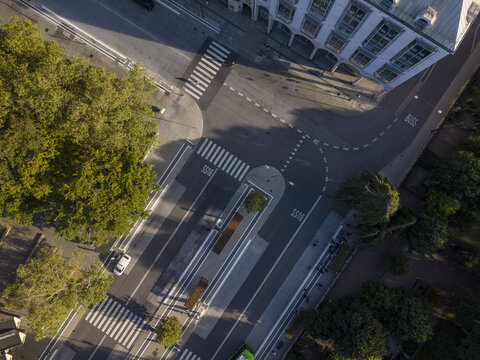 Aerial view of the geometric dance of streets and shadows around Gustav Adolfs torg, where modern lines meet the organic forms of trees, Malmo, Sweden.