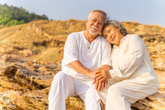 Happy Asian family senior couple enjoy outdoor lifestyle travel nature ocean relaxing together at tropical island beach on summer holiday vacation. Elderly people healthcare and wellness concept. - Powered by Adobe