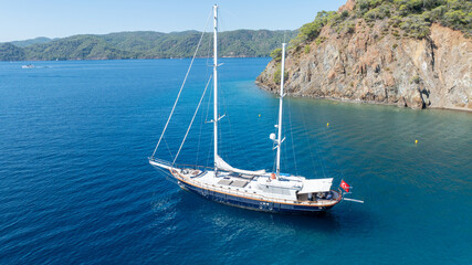 Beautiful aerial view of a classic Turkish gulet sailing in the calm Aegean Sea.