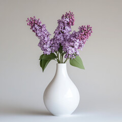 Beautiful lilac flowers in a white vase.