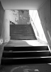 Interior monochrome staircase, dilapidated, sunlit