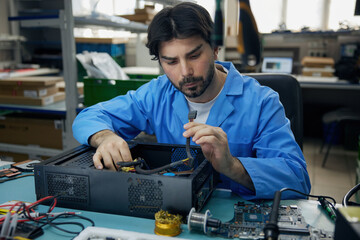 A technician assembles a computer in the lab