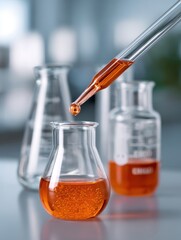 Clear Glass Beaker With Orange Liquid And Dropper In Science Laboratory