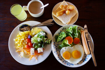 Fresh salad with bread and hot drink with lemon juice breakfast on wooden table