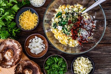 Cooking stuffed portobello mushrooms - ingredients on wooden table. Top view
