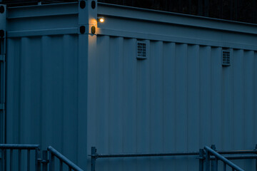 metallic barn outskirts industrial movement object frame cabin in low light dusk lighting with electric lamp illumination view © Artem Kniaz