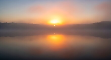 Fototapeta premium A mesmerizing sunrise or sunset over a calm lake, shrouded in thick mist and fog, with the golden light creating a vibrant, symmetrical reflection on the water.
