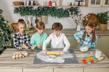 Kids baking holiday cookies in kitchen