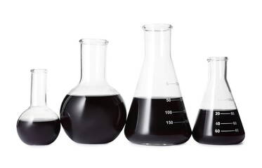 Different laboratory glassware with black liquid isolated on white