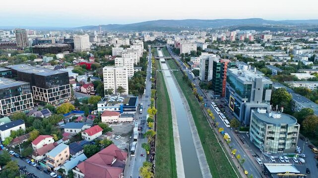 Aerial drone video showing a long line of people walking along Bahlui River in Iasi, Romania, heading toward the Metropolitan Cathedral for Saint Parascheva pilgrimage