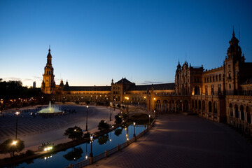 Twilight view of a historic plaza with fountain
