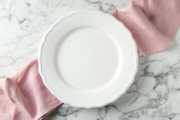 Empty ceramic plate and runner on white marble table, top view