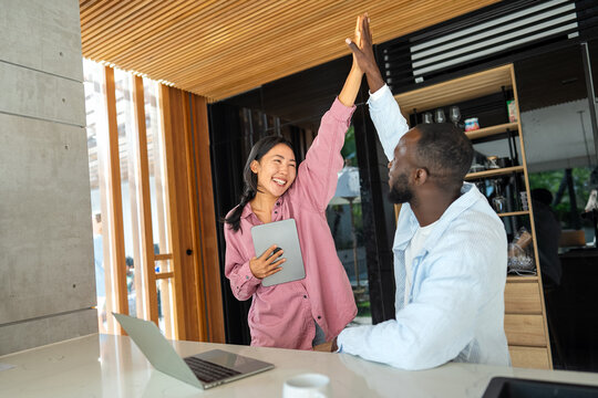 Successful couple working together, celebrating shared achievements. Positive collaboration