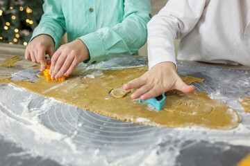 Children using cookie cutters on dough