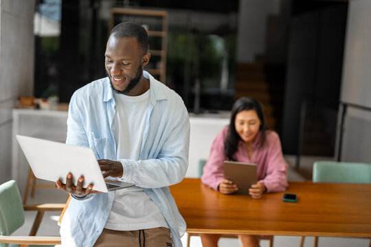 Online entertainment and social media. Diverse, multiethnic couple enjoying the digital world