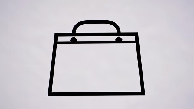 A black outline graphic of a shopping bag with handle on a white background, simple minimalist
