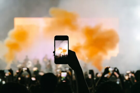 Capturing live music with smartphone amidst smoke and crowd - Powered by Adobe