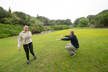Young couple enjoying fun outdoor fitness activity