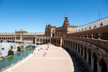 Naklejka premium Historic plaza with canal in Sevilla under blue sky